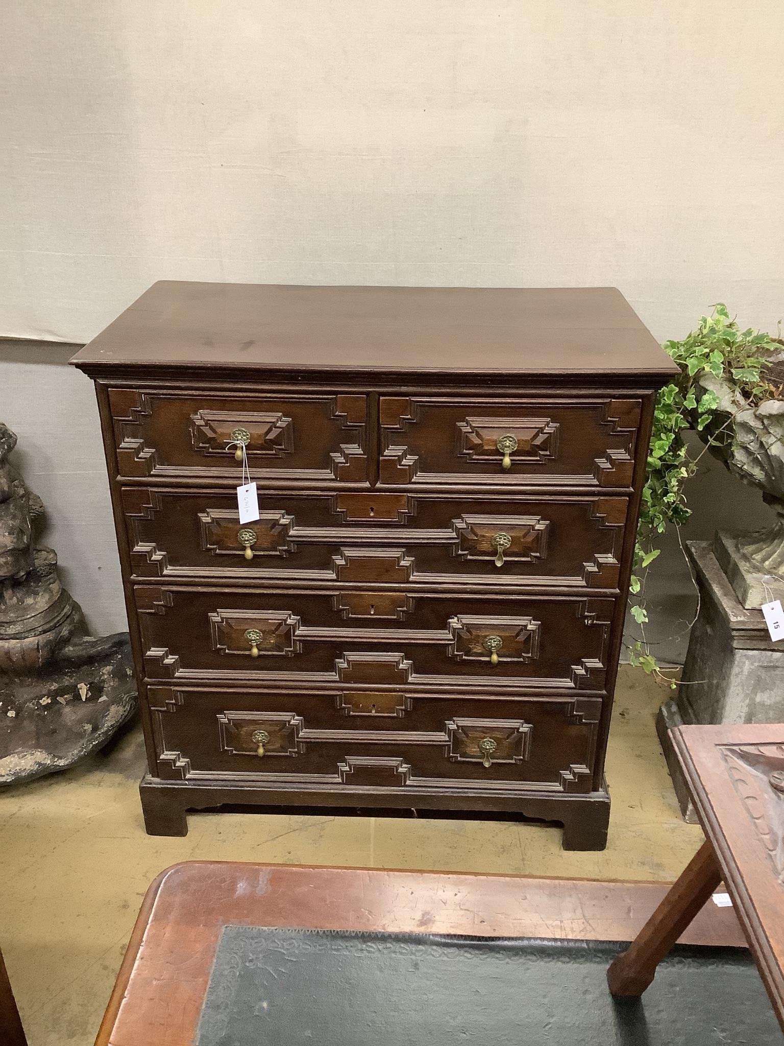 An early 18th century style geometric moulded oak chest of five drawers, width 98cm